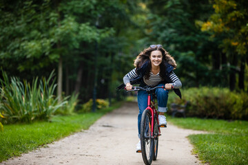 Urban biking - woman riding bike in city park