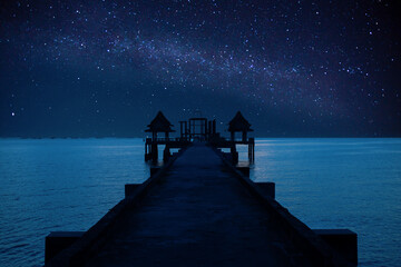 Milky Way galaxy above the sea with bridges at night