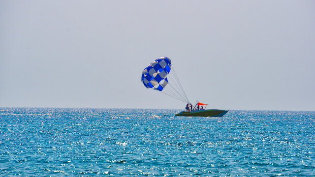 Parasailing, towing behind a man&rsquo;s boat in a parachute system