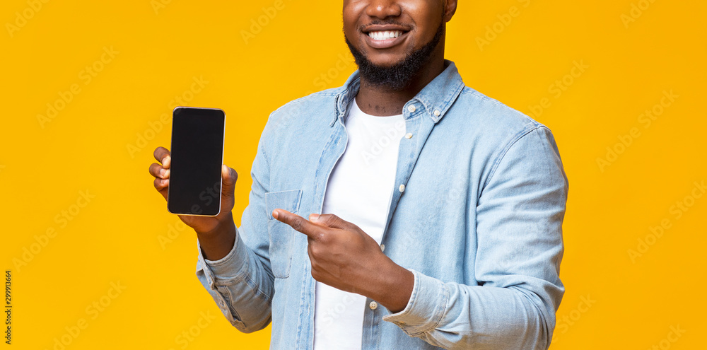 Poster guy holding cellphone with black screen and pointing on it
