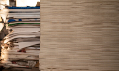 Large stacks of paper in printing office, copy space