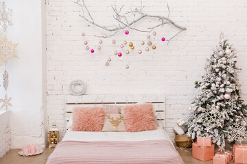 Stylish Christmas white interior, bedroom with a lot of lights and  decorated white branch. Comfort home. Christmas decorated room in loft style