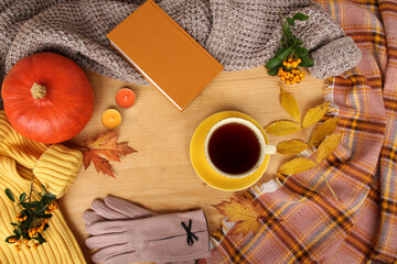 autumn flat in Scandinavian hugg style with hot tea, yellow leaves, cozy knitwear, pumpkin, blank for designer, a template for announcement, invitation, congratulations, calendar, mock up