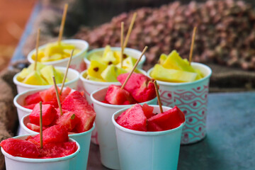 Fresh Organic Fruits Watermelon and Pineapples Served in Paper Cups with Wooden Pickers