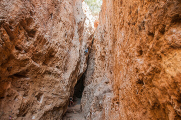 Male rock climber on challenging route in cave. Young man lead climbing in a beautiful grotto. The climber overcomes a difficult route. The athlete trains on a natural relief. Climbing in Spain.