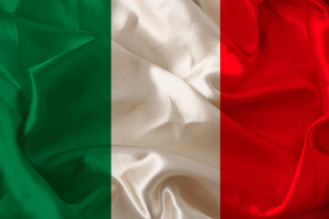 beautiful colored photograph of the beautiful colored national flag of the modern state of Italy on textured fabric, concept of tourism, emigration, economics and politics, closeup