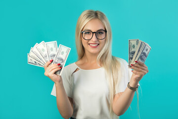 beautiful young woman in glasses with dollars in her hands