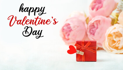 Happy Valentine's day, celebration concept. Greeting card with gift box, heart and pink flowers. gentle lovely image. close up. soft selective focus