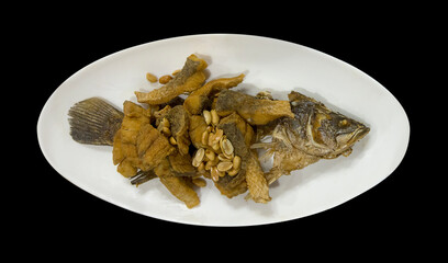 Snapper topped with sauce on white plate