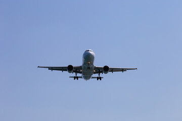 Passenger airplane in the sky close-up. Decrease in height. Greece, Corfu.