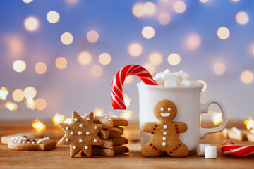 Gingerbread man, cup of hot cocoa with marshmallow and Christmas cane. Winter card.