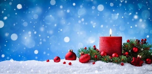 Christmas or advent candle, fir branches and decorations in snow against beautiful winter...