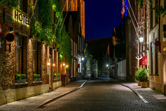 Old street in Bruges (Brugge), Belgium. Night cityscape of Bruges. Typical architecture of Bruges