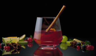 Berry still life with a drink on a black background and cinnamon in a glass.