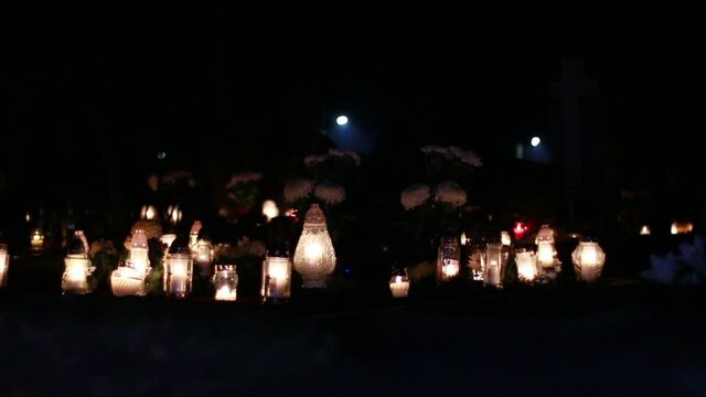 Candles Burning At A Cemetery During All Saints Day In The Dark Of Night