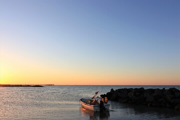 fishing boat and seabridge at sunset