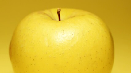 Yellow apple over yellow background