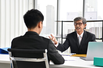 Asian angry boss yelling at employee, business concept