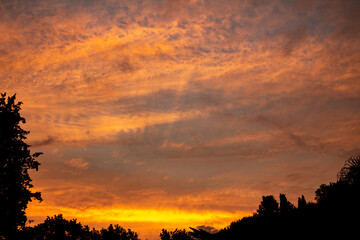 Beautiful and romantic clouds of warm colors during sunset. Sunset as background. Resource for designers.