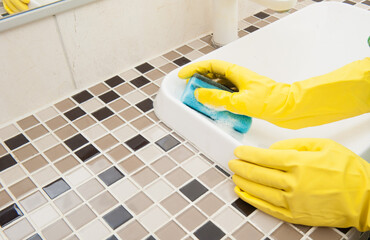 Girl washes a sink in the bathroom