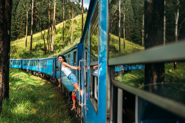 Travel by train. The girl travels by train to beautiful places. Beautiful girl traveling by train among mountains. Travel the world. Trains Sri Lanka. Railway transport. Railway. Transport Asia - obrazy, fototapety, plakaty