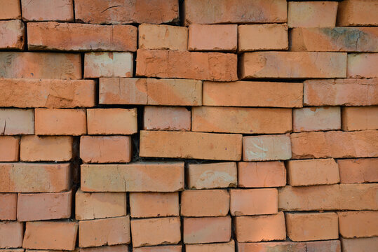 Rows of red bricks laid without mortar on each other