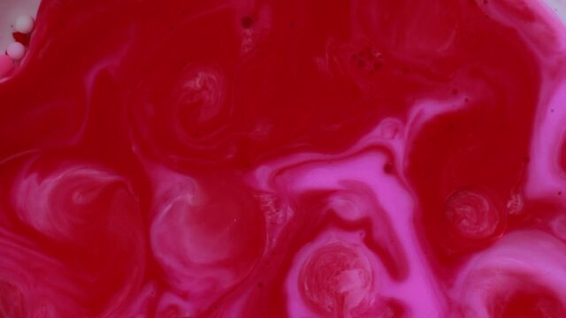 Abstract liquid ink painting texture. Pink and red color swirl marble background. 