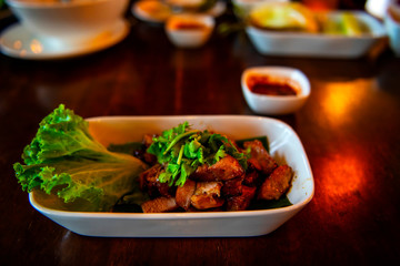 Grilled marinated pork, crispy delicious flavors popular with spicy sauce with a taste for the local cuisine eaten Thailand