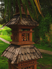 Wood carving decoration detail of the ancient garden lamp, Asian style, vertical image, selective focus on the foreground
