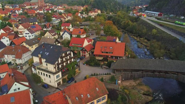 4k Aerial view of wood bridge over Murg river and Forbach village, Germany