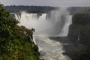 Fototapeta premium The main attraction of Brazil and Argentina is the famous Iguazu Falls among the lush green jungle. Huge streams of water fall to the ground. UNESCO World Heritage. Picture from paradise.