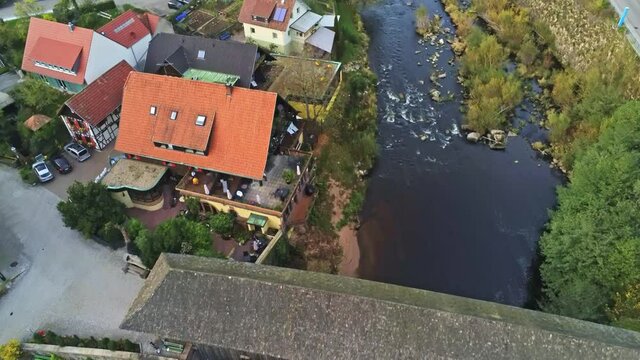 4k Aerial view of wood bridge over Murg river and Forbach village, Germany