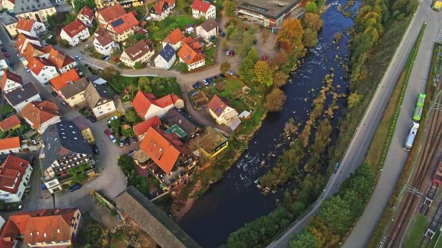 4k Aerial view of wood bridge over Murg river and Forbach village, Germany