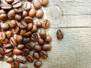 large grains of coffee on a wooden table. place for text