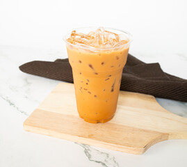 Thai tea in plastic glass on white background, Iced milk tea or Thai milk tea on white background