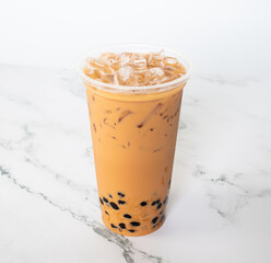 Taiwan milk tea with bubble plastic glass on wood background