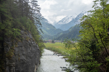 Charming scene of aare river between cliff and fresh green trees in Aare gorge(Aareschlucht), Meiringen, Switzerland