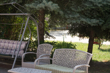 table, chairs, bench and swing in the garden of nursing home