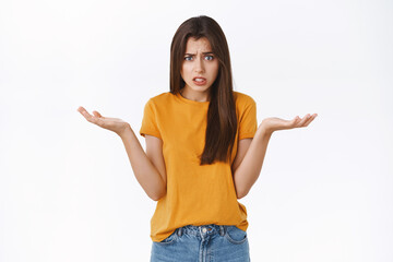Concerned, pissed uneasy young woman nervously asking question, cant understand anything, shrugging...