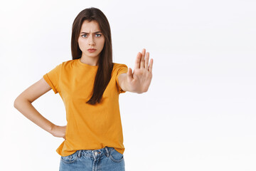 Serious-looking confident and angry assertive young woman want prevent friend driving, pull hand...