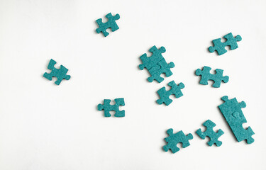 Blue jigsaw puzzles scattered on white background
