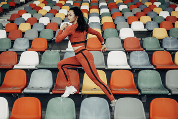 Naklejka premium Portrait of One Sports Fitness Girl Dressed Fashion Sportswear Outfit Doing Jogging and Run at the City Stadium, Healthy Lifestyle Concept