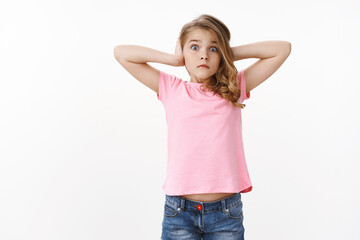 Shocked worried cute blond girl stare camera panicking, nervously shut ears hear unappropriate...