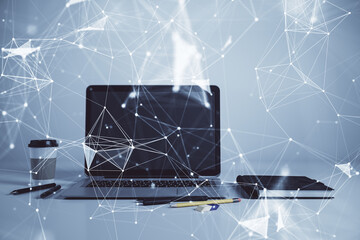 Technology theme hologram and desktop office computer background. Double exposure. Concept of high technology