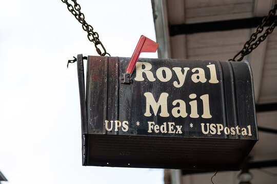 New Orleans, USA - April 23, 2018: Old town street in Louisiana city with closeup of sign for Royal Mail UPS FedEx and USPS