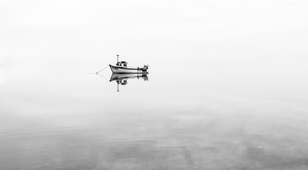 Boat on flat calm water 