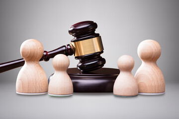 Wooden Pawns In Front Of Gavel And Mallet