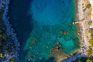 Fototapeta na wymiar Aerial bird's eye view photo taken by drone of famous beach of Anthony Quinn with clear water rocky seascape, Rhodes island, Greece.