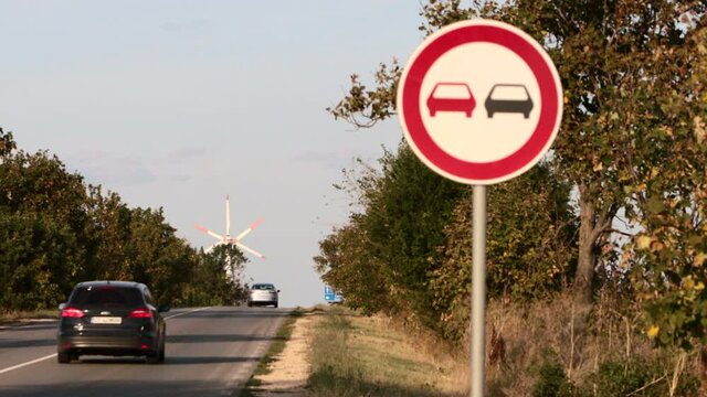 Cars passing by a road sign