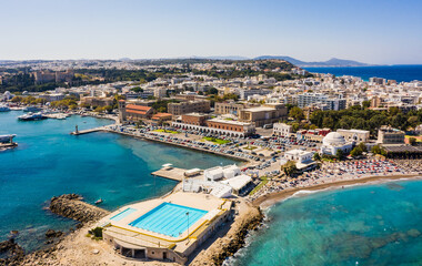 Fototapeta na wymiar Aerial birds eye view drone photo of Rhodes city island, Dodecanese, Greece. Panorama with Mandraki port, lagoon and clear blue water. Famous tourist destination in South Europe